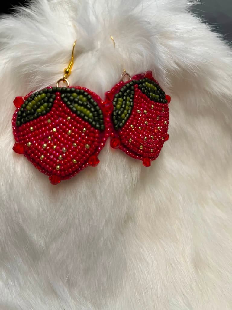 Beaded strawberry earrings in red with green leaves and gold seed detail